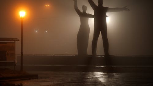 People Walking in the Main Square of Novosibirsk on a Foggy Night