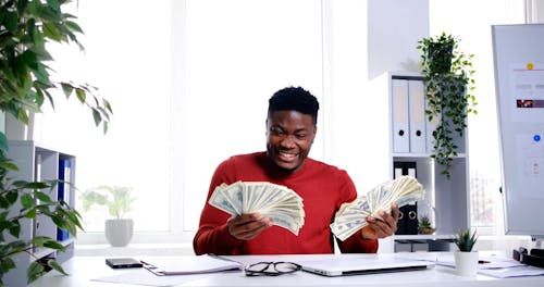 Man Smiling and Throwing Cash