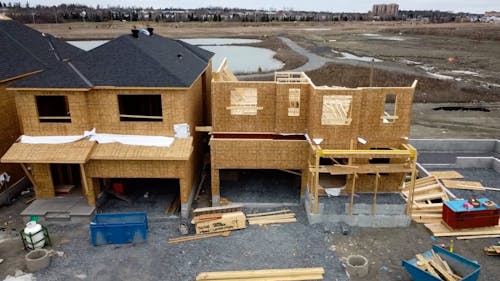 A Row of Wooden Houses under Construction 