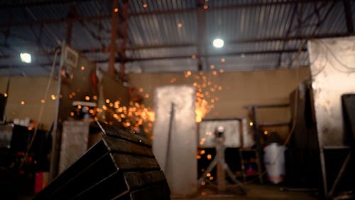 Sparks Flying while a Man is Working with Metal 