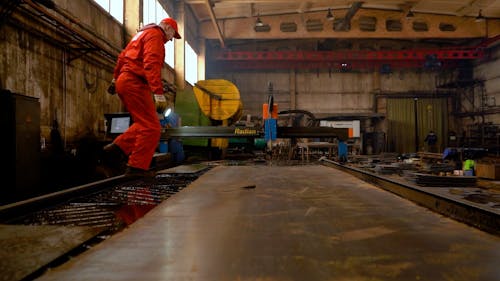 A Man Working with a Plasma Cutting Machine