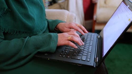 A Person Typing on the Laptop
