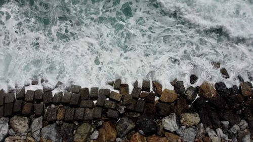 Top View of Waves Crashing on a Rocky Shore