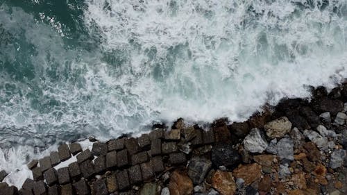 Top View of Breaking Waves on a Rocky Shore