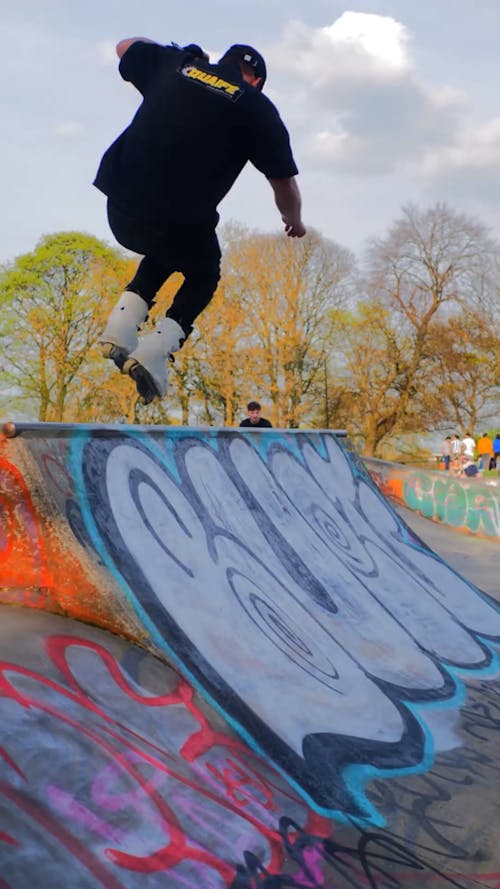 A Man Roller Skating at a Skatepark  