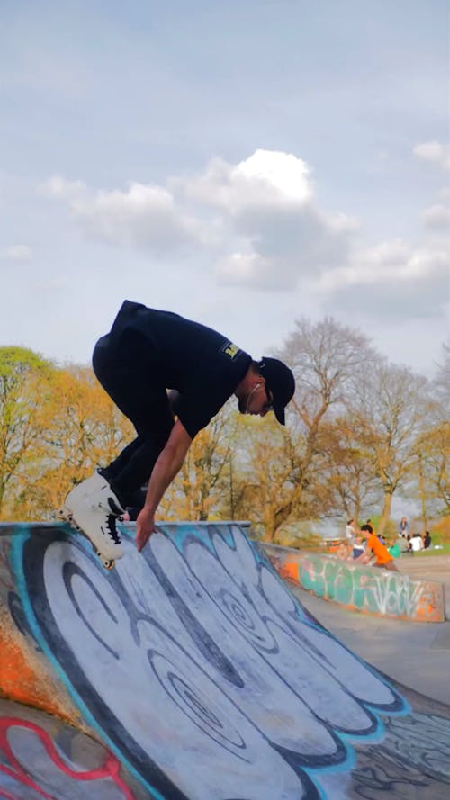 A Man Performing Tricks at a Skatepark 