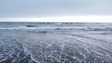 drone footage of beach and sea waves