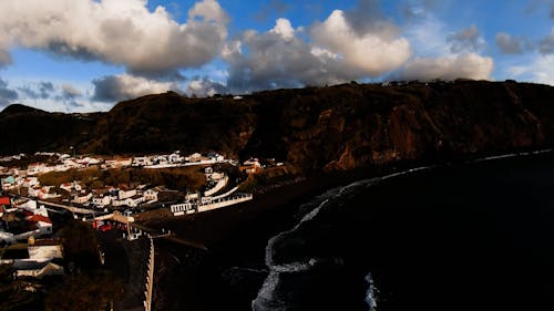 Drone Footage of a Coastal Town and a Black Sand Beach