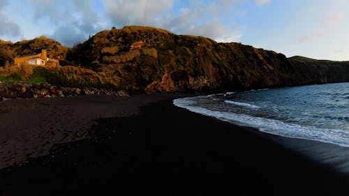 Drone Video of a Black Sand Beach on a Volcanic Island 