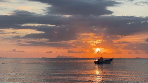 A Boat near the Shore at Sunset 