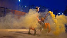 Women Playing with Yellow Smoke Flare and Shopping Cart