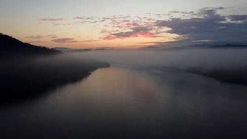 Drone Footage of Low Clouds over a River at Sunrise