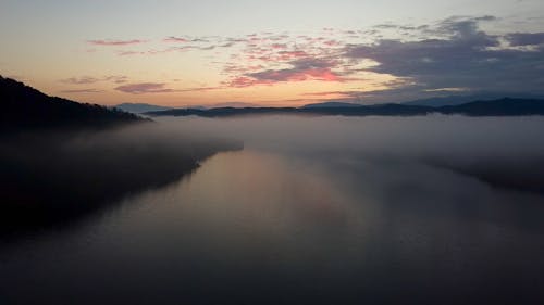 Drone Video of Low Clouds over a River at Sunrise