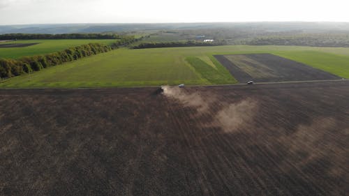 Aerial View of Tractor Plowing a Field 