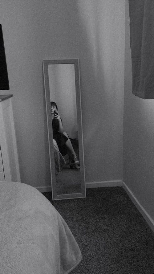 Woman in Mirror in Bedroom