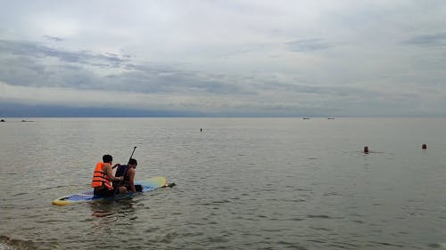 Men on Raft on Sea