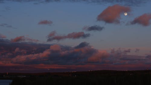 Moon and Clouds on Sky in Evening