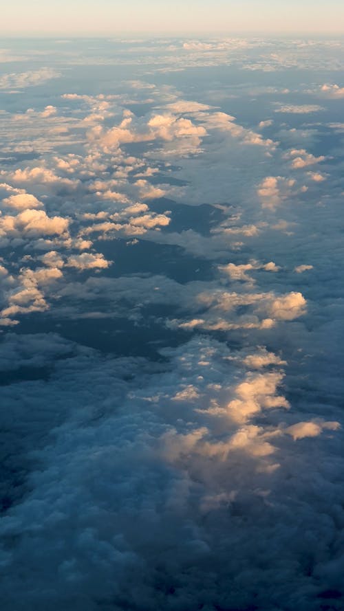 View from an Airplane Flying over the Clouds