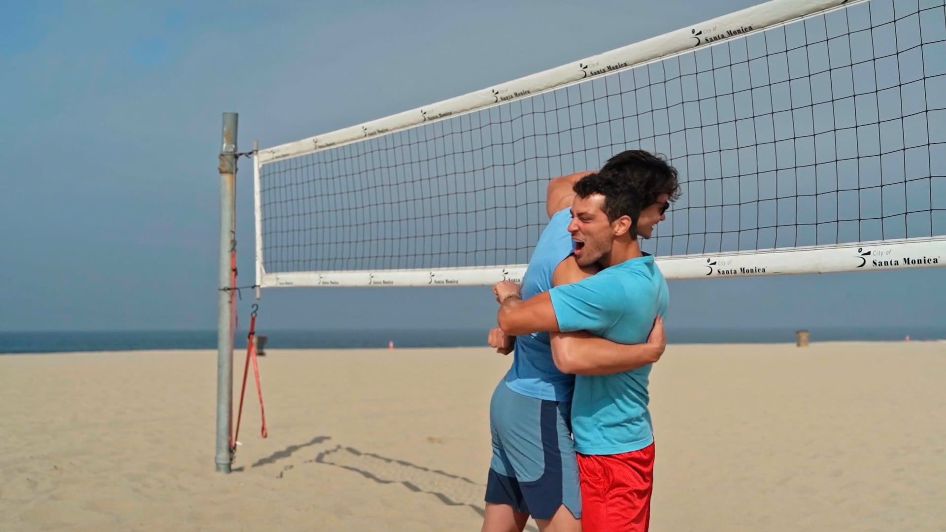 Two Players Hugging And Celebrating At A Beach Volleyball Court Free