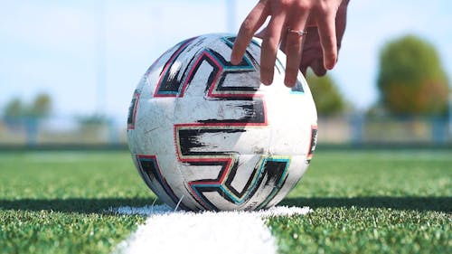 Close up of a Soccer Player Picking up the Ball