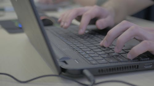 Close up of a Person Typing on a Laptop Computer