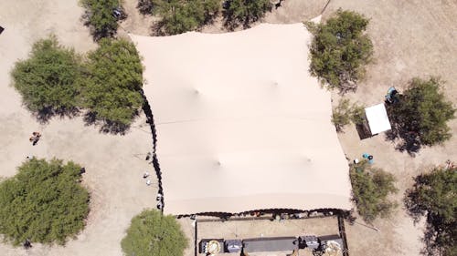 Top View of a Music Festival Tent by a Body of Water