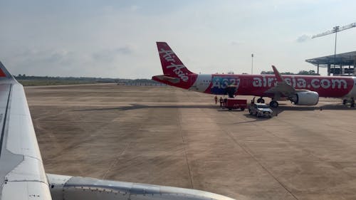 Window View of an Airplane Parking at the Airport