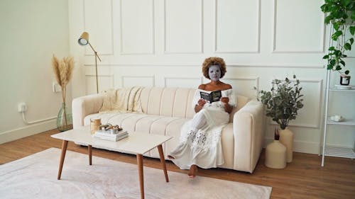 A Woman Reading a Book while Using a Sheet Mask