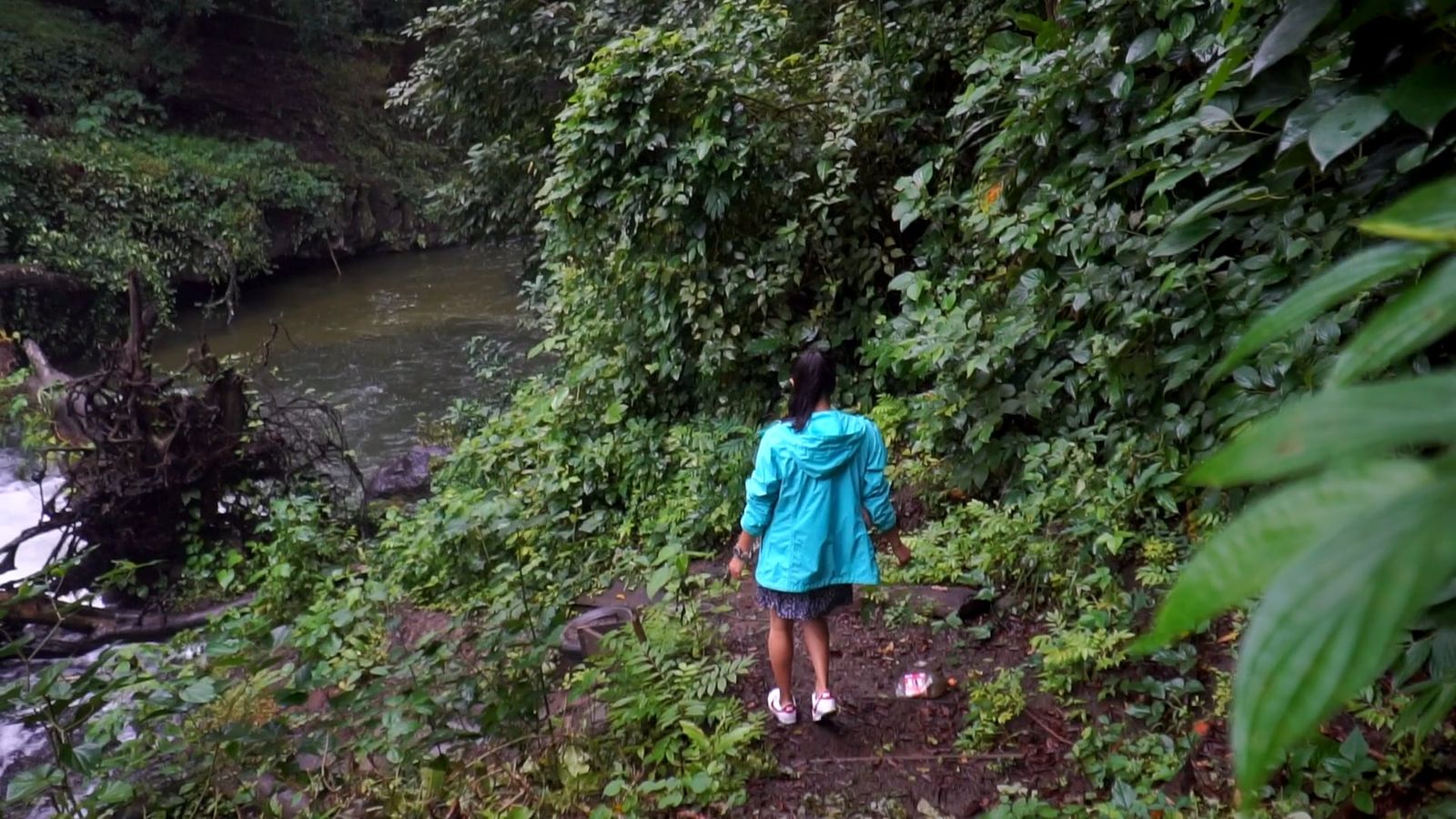 A young girl standing in the woods with a waterfall Free Stock Video ...