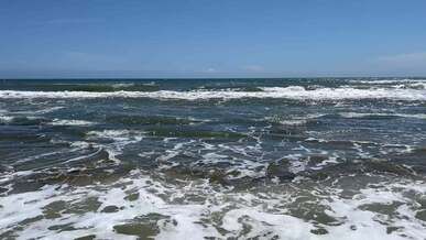 clear sky over waves on sea shore