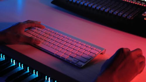 Close-up View of Hands on Mouse and Keyboard