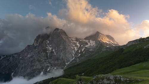 Time Lapse of Moving Clouds over a Mountain Peak