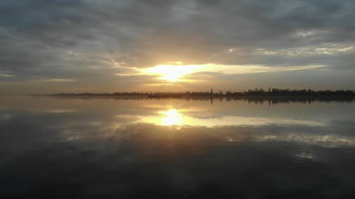 A River under a Dramatic Sunrise Sky