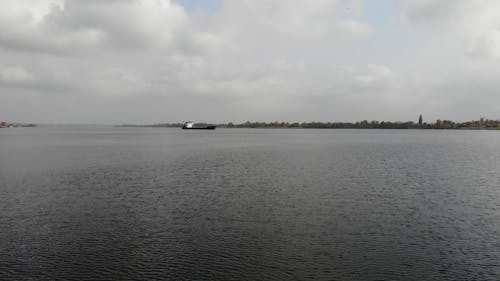 Drone Footage of an Empty Cargo Ship Sailing in a River 