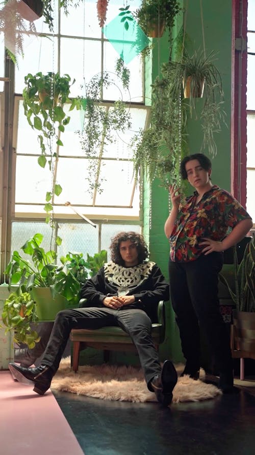 Two Young People Posing with Decorative House Plants