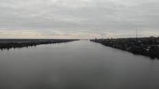 Drone Video of a Wide River under a Grey Sky 