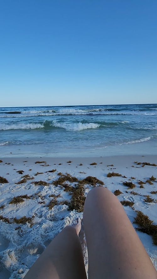 Legs Lying Down on Beach