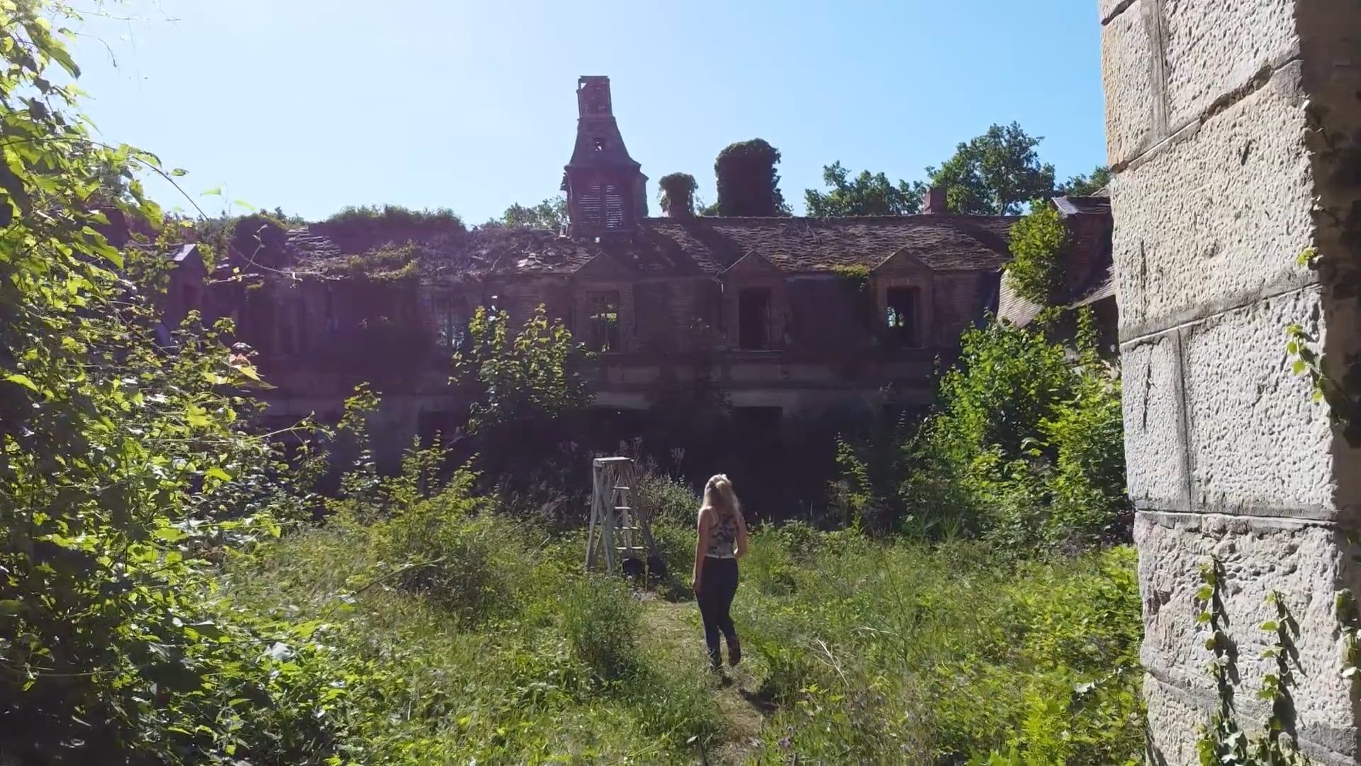 A Woman Walking in the Garden of an Abandoned Mansion Free Stock Video ...