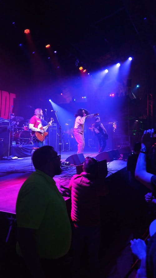 Rock Band Performing on Stage During Concert