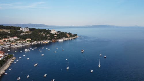 Drone Shot of a Coastal Town and Boats in Sea, Rabac, Croatia