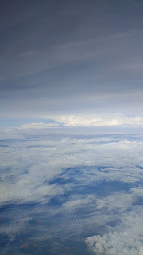 View of Clouds and Sky from a Flying Airplane