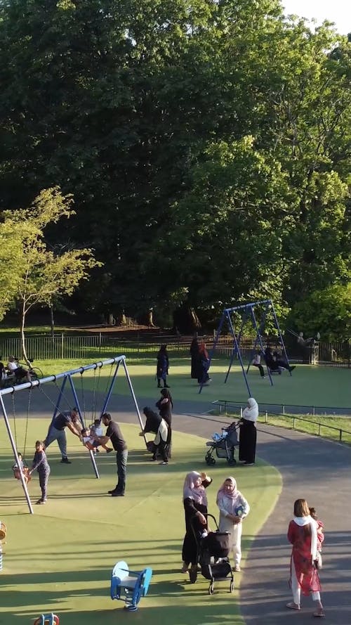 People Playing with Children at a Playground