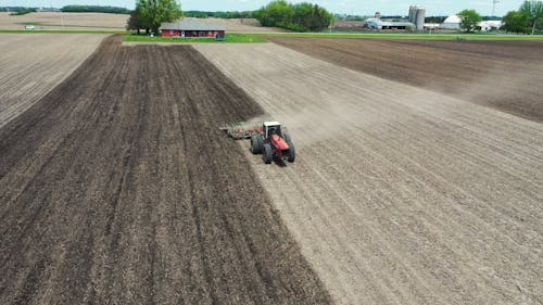 Drone Shot of a Tractor Plowing a Field