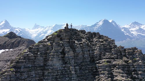 Two Men Standing on a Mountain Peak