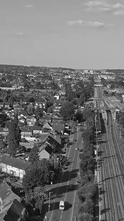 Aerial Shot of a Train in a Town in Black and White