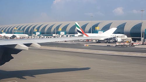 Window View of a Plane Taxiing on the Runway at Dubai Airport