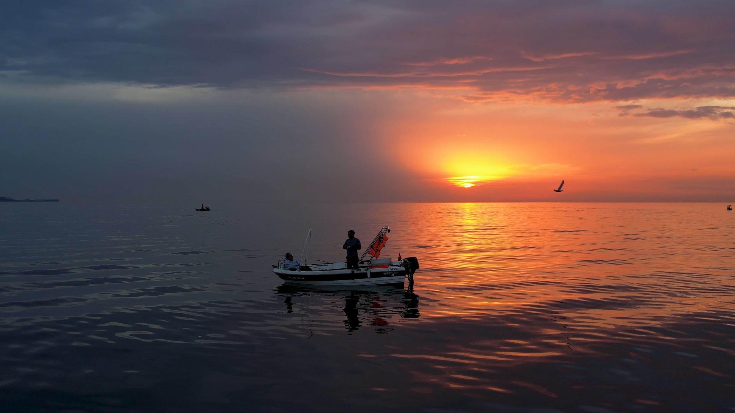 Drone Shot of a Boat with Two Men on Sea at Sunset Free Stock Video ...