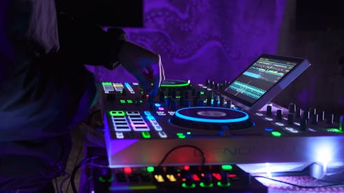 A Person Using a DJ Mixer