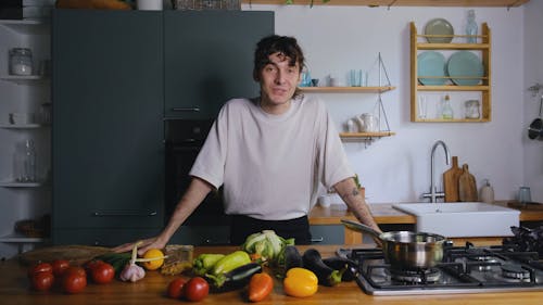 A Young Chef Talking and Showing Ingredients for a Healthy Meal 