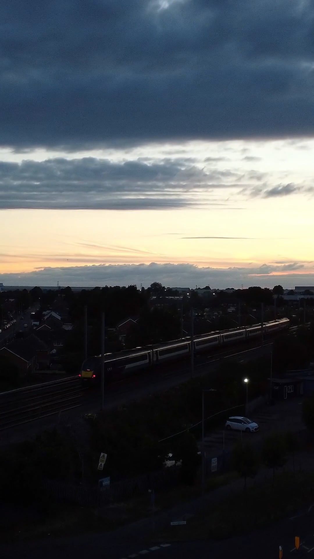 drone shot of a train moving through a town at dusk 12711502 — free pexels stock footage